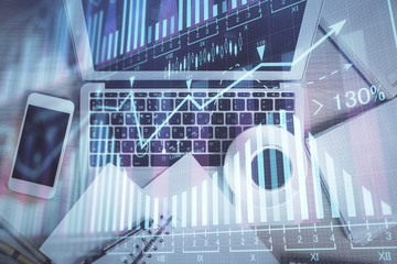 Stock market chart and top view computer on the table background. Double exposure. Concept of financial analysis.