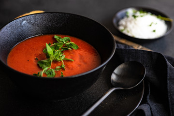 Gazpacho soup served in black bowl