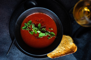 Gazpacho soup served in black bowl