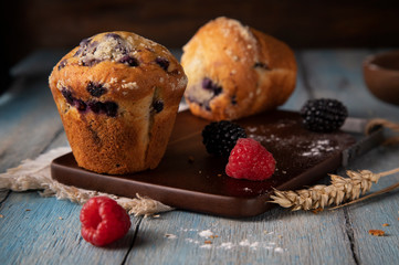 
Cupcakes and berry on wooden board
