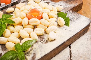 Gnocchi with potatoes. Traditional italian food from Rome, Sardinia, south of italy. Homemade gnocchi with parmesan, egg, cornmeal (semolina). On a wooden table. High quality photo. Above. Copy space 