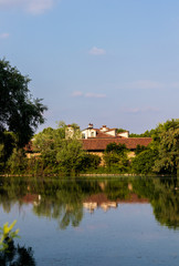 Fototapeta na wymiar lake landscape with house reflected in water