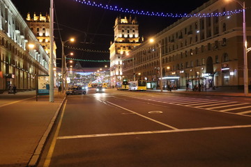 night street in Minsk with cars and buildings