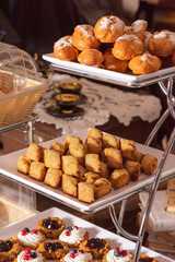 Sweet and delicious food on trays.Fruit tarts with sugar powder on trays.
