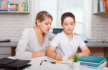 Child doing homework at home with books. Education, home schooling