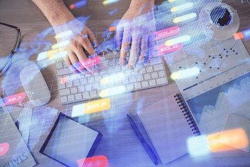 Double exposure of man's hands typing over computer keyboard and data theme hologram drawing. Top...
