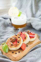 A healthy breakfast of pancakes, strawberries, chocolate, and honey