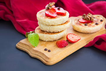 A healthy breakfast of pancakes, strawberries, chocolate, and honey