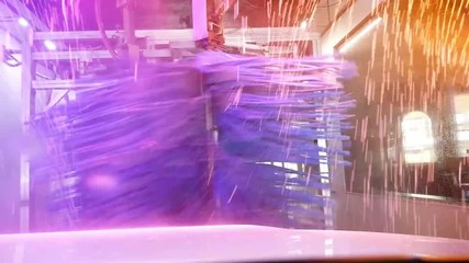 Carwash with rotating brushes, water jets and dryer