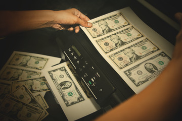 Concept counterfeiting of banknotes is illegal : Man's hands illegally produce large amounts of...