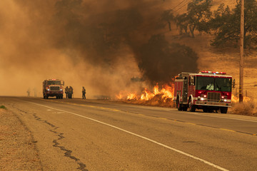 Fire crews work to control a fire © James