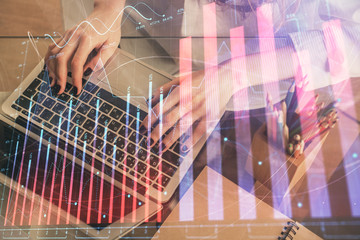 Double exposure of woman hands typing on computer and forex chart hologram drawing. Stock market invest concept.