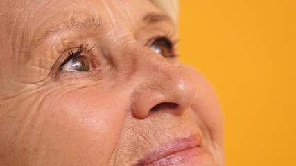 Close up shot of the green eyes of an elderly lonely woman. High quality photo