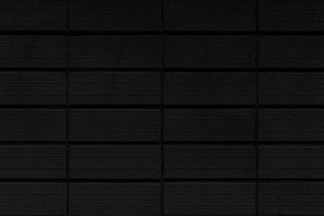 Black stone block wall seamless background and pattern texture