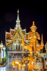 Thai Giant Statue in front of Pillar Shrine in Udon thani province,Thailand, Nightime. They are public domain or treasure of Buddhism, no restrict in copy of use. soft focus.