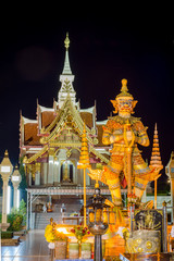 Thai Giant Statue in front of Pillar Shrine in Thailand, Nigh time. They are public domain or treasure of Buddhism, no restrict in copy of use. have thai language in picture