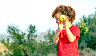 nice image of boy with apple pricking with a fork and smiling
