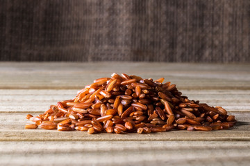 red rice isolated on wooden table in Brazil