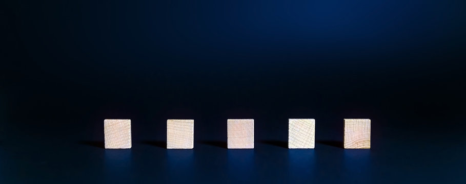 Blank wooden square letters on a blue background