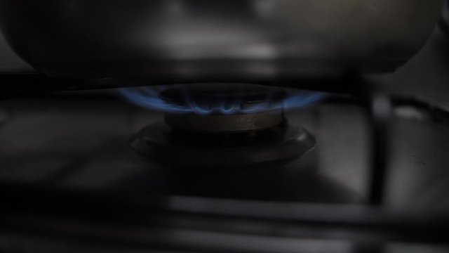 Taking Cooking Pot Over Gas Stove  Nozzle