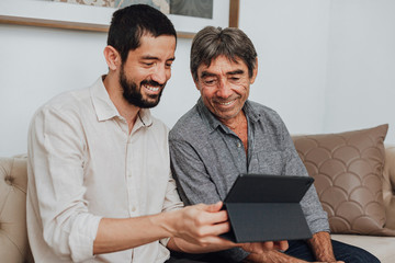 Portrait of father and his adult son at home