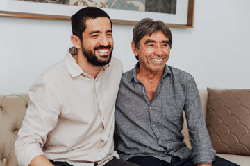 Portrait of father and his adult son at home