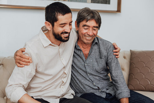 Portrait of father and his adult son at home