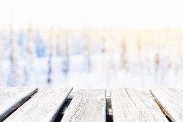 empty wooden table on the blur background of winter forest