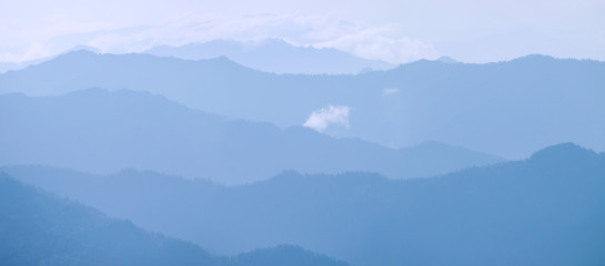 Mountains in the morning haze, blue natural background