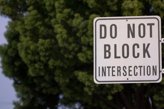 Do not block intersection sign attached to a post on a city street used for avoidance of traffic obstructions.