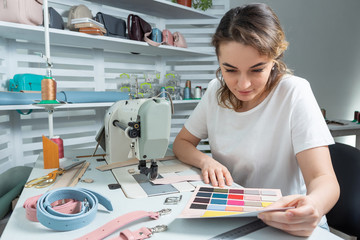 girl worker examines a palette of samples