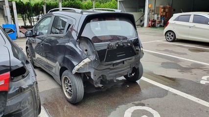 Car with a broken rear bumper waiting to be repaired at the car service center in Korea.