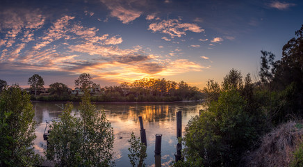 Beautiful Panoramic Riverside Sunrise with Reflections