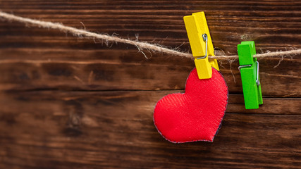 Handmade red heart attached to the rope using clothes pin. Valentine's Day card