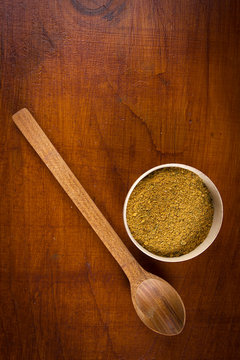 Yellow Spice In A Wooden Bowl