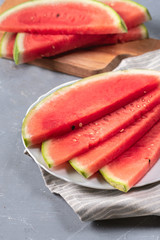 Watermelon pieces on a plate on light backgound