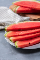 Watermelon pieces on a plate on light backgound