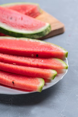 Watermelon pieces on a plate on light backgound