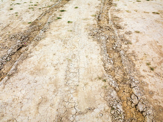Tire tracks on muddy abandoned country road