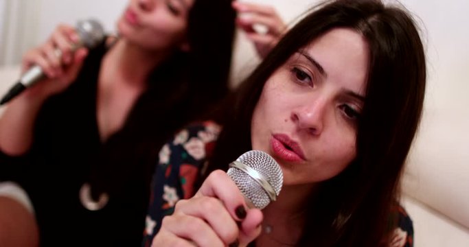 Women singing karaoke entertainment, Happy two women sing karaoke holding microphone