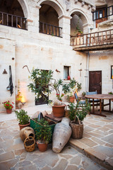 Fototapeta na wymiar Turkish courtyard with green plants and old pitchers