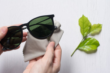 Close up cleaning glasses by microfiber cloth for cleaning lens and glasses concept.Close up...