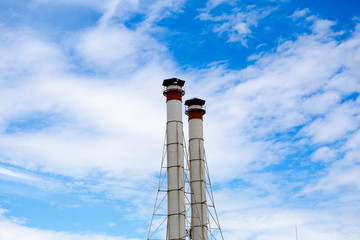 Two chimneys against a blue sky