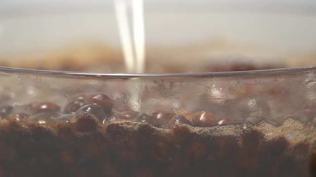Cooking, boiling brown sugar flavor tapioca pearl balls, ingredient of bubble tea, preparing food and drink, close up, recipe cookbook steps design concept, slow motion.