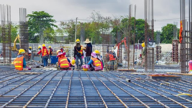 Footage 4k Timelapse, View of construction workers fabricating steel reinforcement bar at the construction site, The reinforcement bar was tied together.