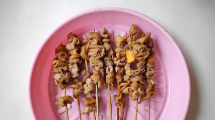 sate usus or chiken intestines satay. traditional indonesian street food