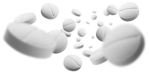 White round tablets levitate on a white background