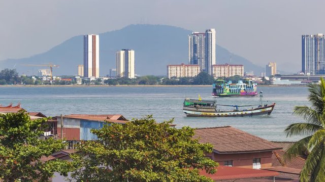 Footage 4k Timelapse of cityscape and boat traffic in a harbor in the morning as background on a mountain range in Butterworth, Clan jetty Georgetown, Pulau, Penang, Malaysia.