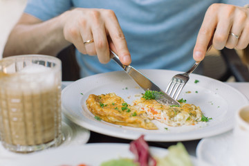 Close up of tasty omelet with bacon, vegetables and fresh greens . Breakfast concept.