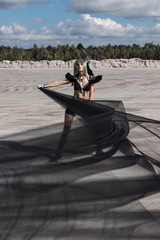 Girl in metal wig and in black retro-futuristic festival outfit. Burning man style photoset in desert.